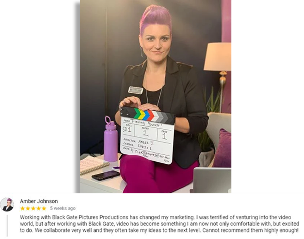 Amber Johnson gives a five-star review of Black Gate Pictures Productions, holding a clapperboard on a studio set. She shares how video transformed her marketing strategy, praising the team’s collaboration, creativity, and ability to elevate her ideas. Studio lighting and production setup are visible.